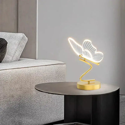 Gold-toned butterfly led table lamp with illuminated translucent wings and sleek curved base for bedroom decorbites butterfly led light