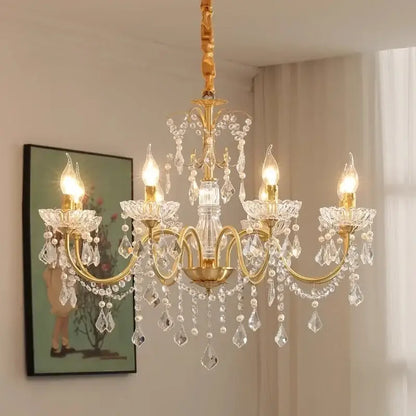 Elegant gold-toned decorbites crystal chandelier light with crystal droplets and floral-shaped arms for dining room decor
