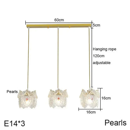 Gold-toned carved glass pearl chandelier with three lace-like glass shades and illuminated e14 bulbs for dining room decorbites