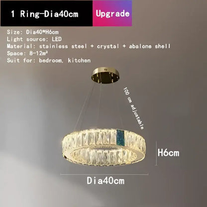 A modern gold decorbites crystal led chandelier with circular stainless steel frame and abalone shell accent for dining rooms