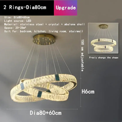 Gold-toned decorbites crystal led chandelier with two interlocking rings featuring crystals and abalone shell accents