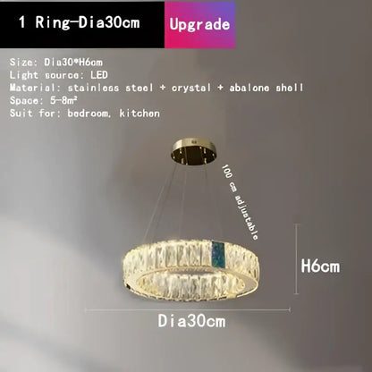 A gold circular decorbites crystal led chandelier with stainless steel frame clear crystals and abalone shell accent