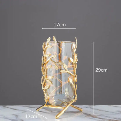 A tall transparent glass vase with golden leaf and branch metal frame coral crystal tree living room decor