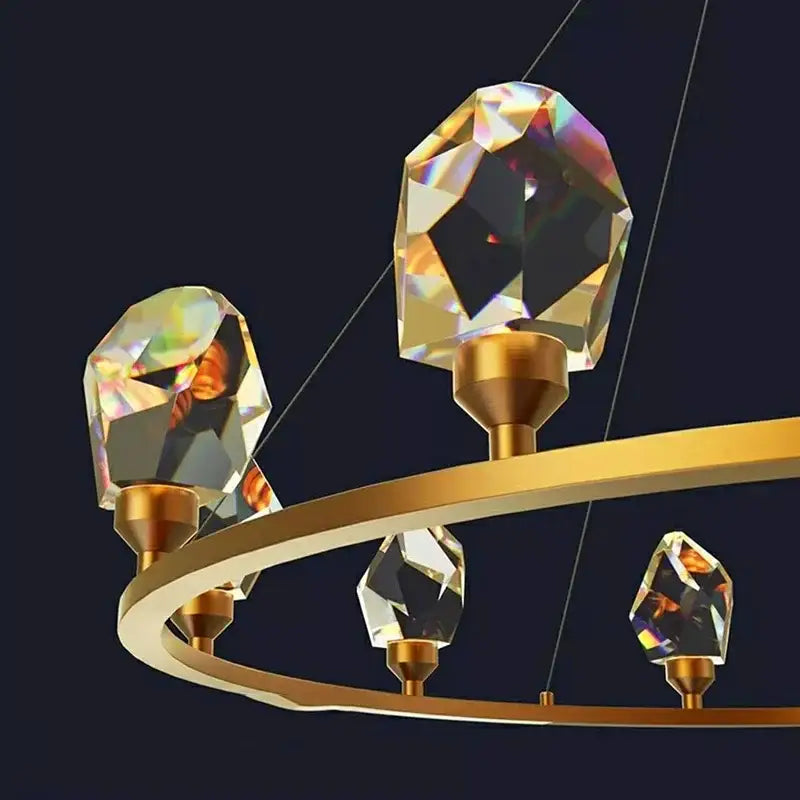 Gold crystal circular dining room chandelier pendant light with sleek gold frame and four faceted crystal pendants refracting light decorbites dining room