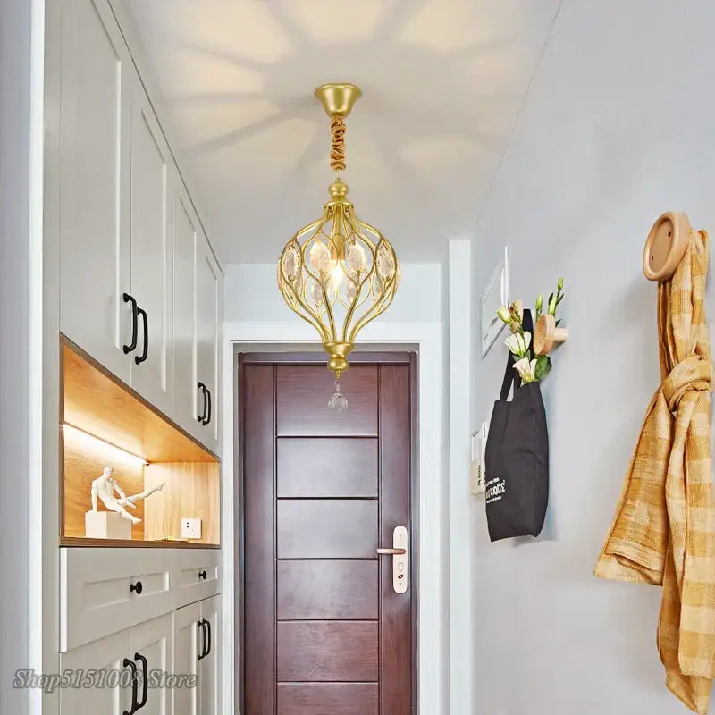 Gold decorbites art design pendant lights gold ornate chandelier with crystal accents hanging above wooden door