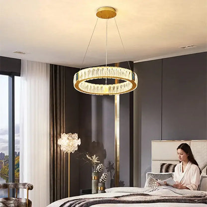 A modern gold decorbites crystal round ceiling chandelier with clear crystal accents for dining room use