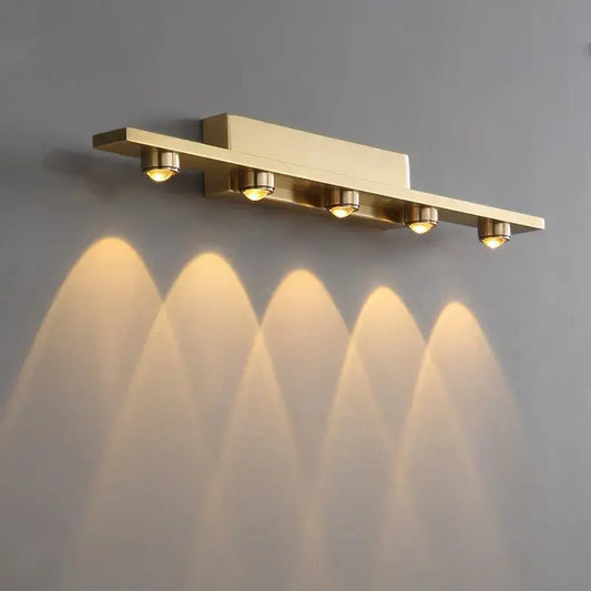 Gold finished iron art mirror wall sconce with five adjustable spotlights casting warm focused beams by decorbites iron art