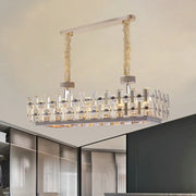 A contemporary rectangular hanging decorbites 12-bulb gold island light with clear crystal blocks and chrome frame
