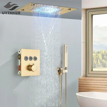 Gold-finished rectangular rainfall waterfall head with integrated led lighting and matching bathtub mixer tap control panel