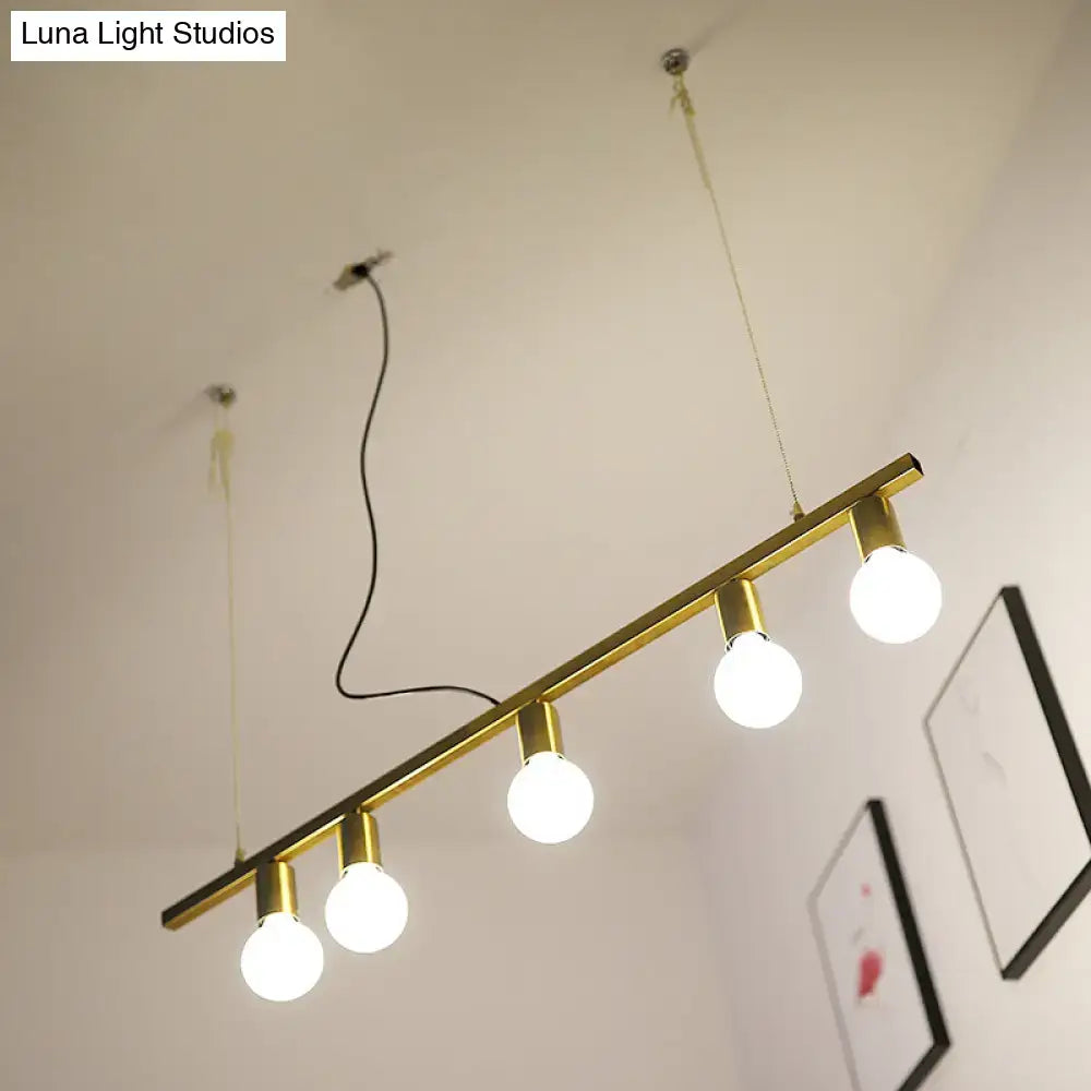 Gold-toned metal linear island pendant light with four exposed globe bulbs for dining room lighting