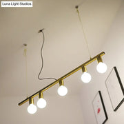 Gold-toned metal linear island pendant light with four exposed globe bulbs for dining room lighting
