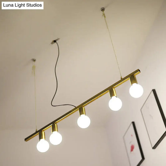 Gold-toned metal linear island pendant light with four exposed globe bulbs for dining room lighting
