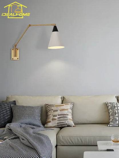 Gold lustre brass swing arm wall lamp with adjustable gold-toned arm and white conical shade by decorbites
