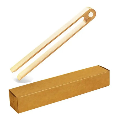 Light-colored bamboo toaster tongs with a smooth natural finish and rounded ends for kitchen bread tools
