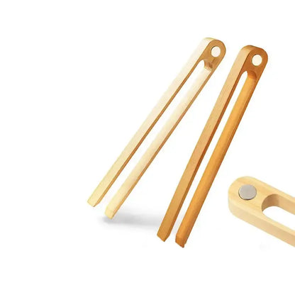 Light-colored bamboo toaster tongs with a smooth natural finish and rounded ends for kitchen bread use