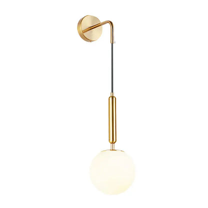 Gold-toned light fixture with a sleek curved arm, black cable, and frosted opal glass spherical shade for bedroom use