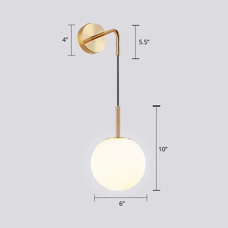 Gold-toned light fixture with a sleek curved arm and frosted opal glass spherical shade for bedroom wall mounting