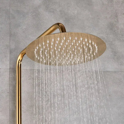 Gold-toned round showerhead with multiple water jets streaming downward in a shower faucet set bathroom system
