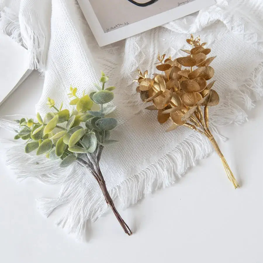 Two artificial eucalyptus leaves sprigs in muted green frosted and metallic gold for wedding decor by decorbites eucalyptus leaves