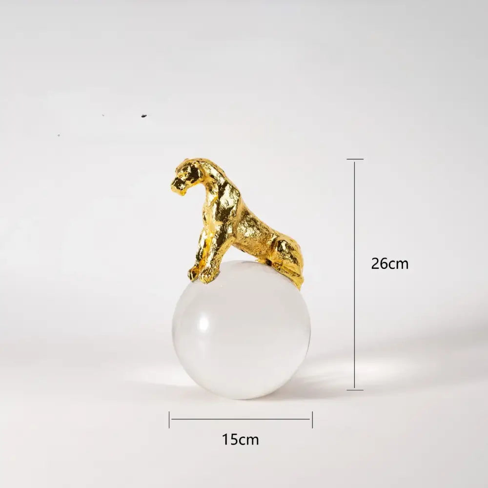 Gold and silver leopard crystal ball metal sculpture featuring a golden leopard figurine on a translucent white sphere decorbites crystal ball decor