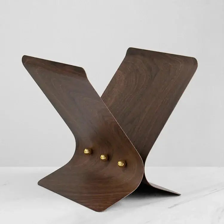 Dark wood magazine stand with curved design and gold-toned studs for elegant decorbites leopard crystal ball decor