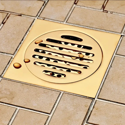 Gold-colored circular floor drain with horizontal slats and raised rim for decorbites gold square bathroom shower drain
