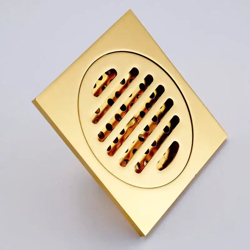 Gold decorbites gold square bathroom shower drain with interchangeable circular slotted grate design