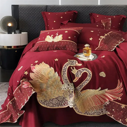 Luxurious burgundy satin bedding set with gold and silver embroidered swans floral details star motifs and netting trim decorbites gold swan