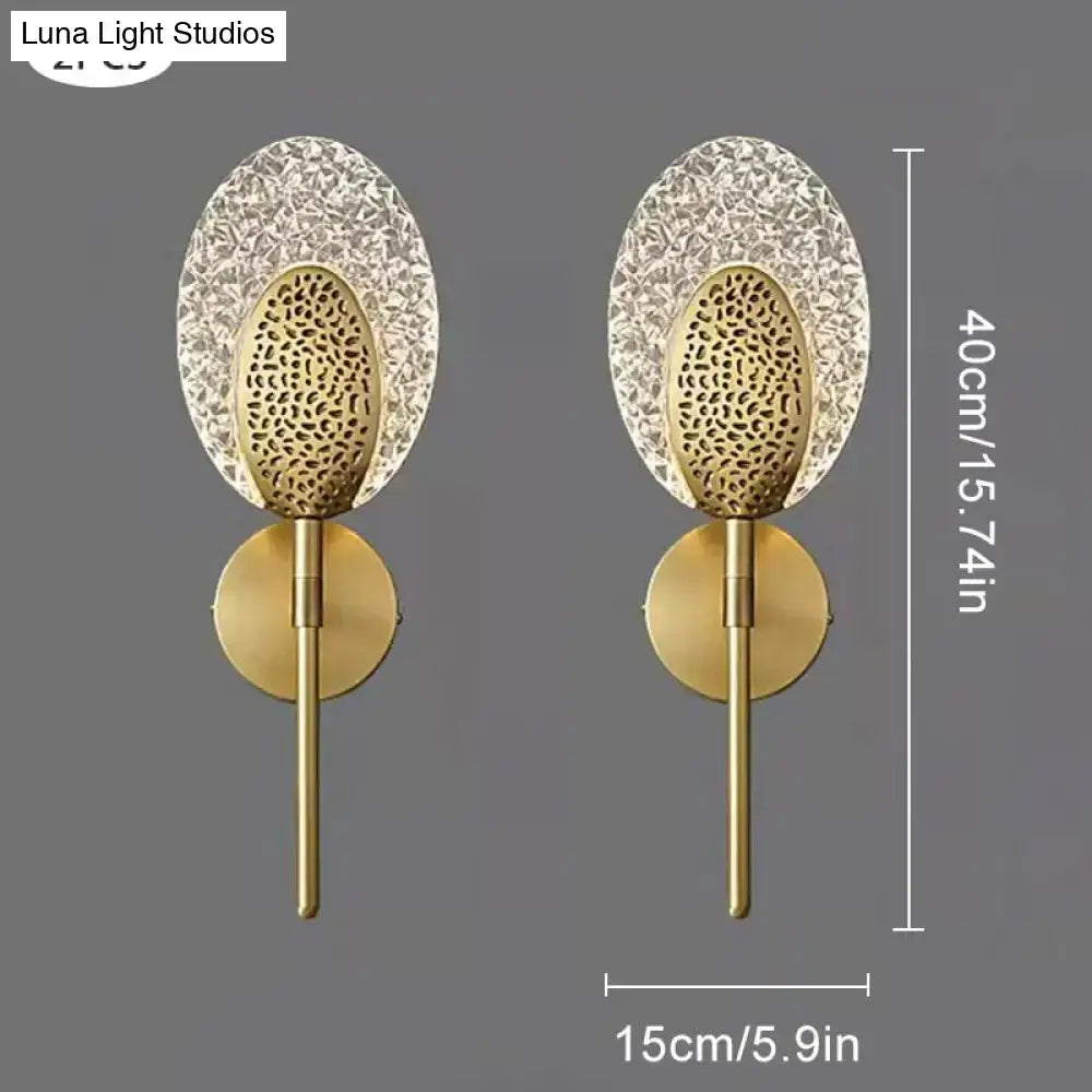 Gold finished led wall lamp with intricate textured glass panels and circular base for indoor lighting in bedroom