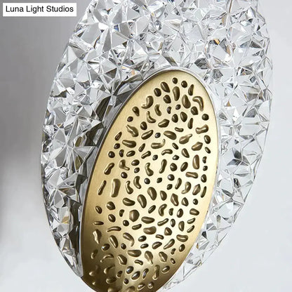 A modern gold textured glass led wall lamp with a faceted crystal shell and brass inner panel for indoor lighting