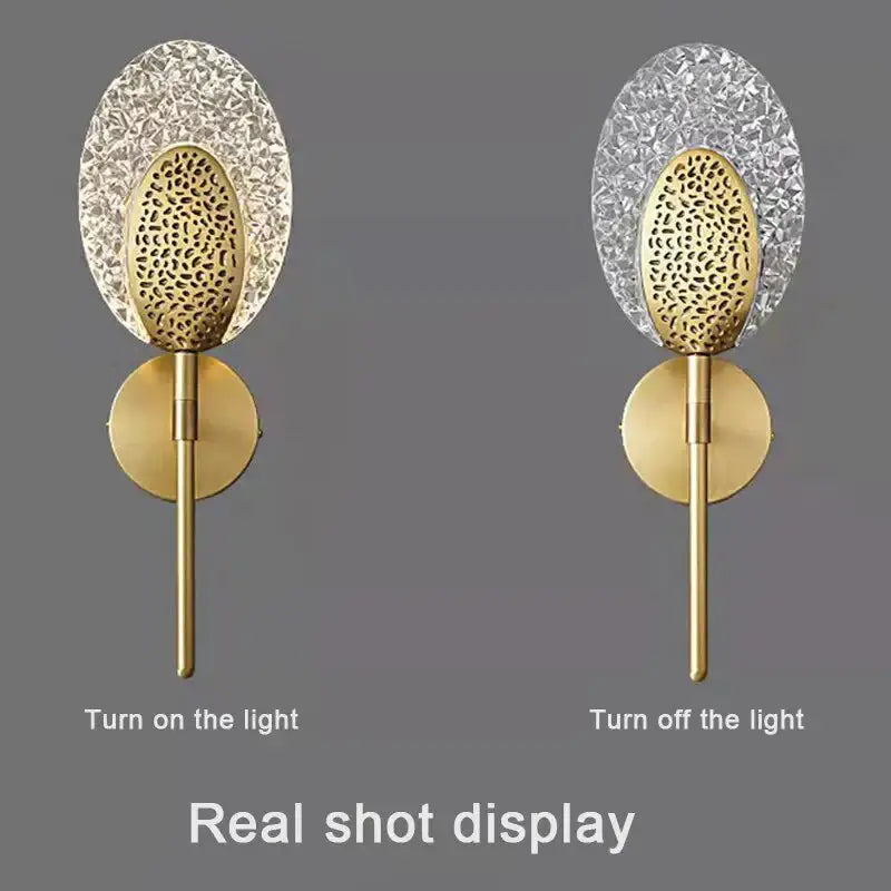 Gold-toned led wall lamp with textured glass oval crystal backplate and patterned disc for indoor lighting in bedroom
