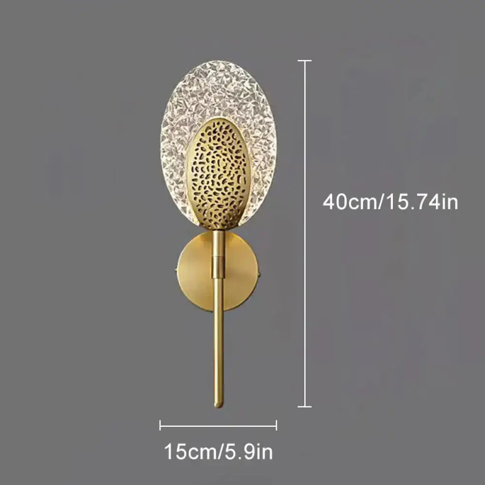 Gold textured glass led wall lamp with oval cut-out shade and decorative element for indoor lighting in bedroom