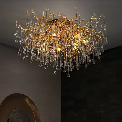 Gold tree branch chandelier with crystal droplets in gold style designed for elegant dining room lighting