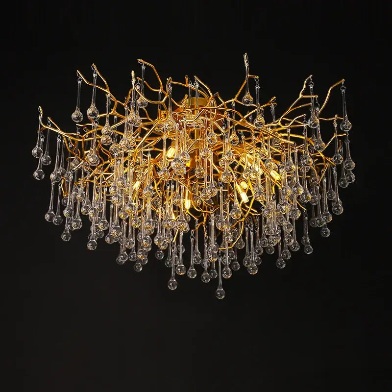 Gold tree branch chandelier featuring clear crystal droplets designed for elegant dining room lighting