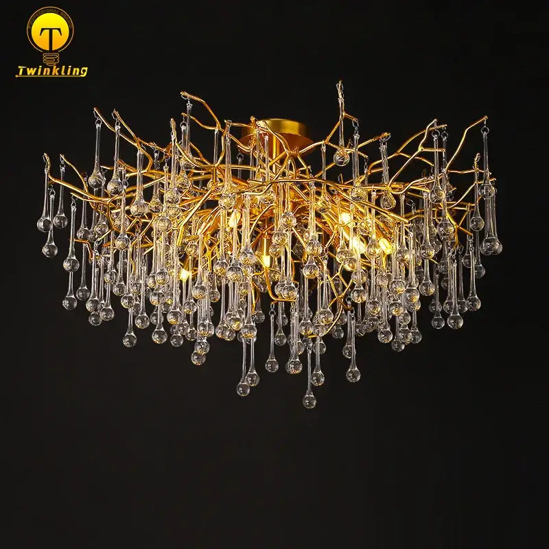 Gold tree branch chandelier featuring dangling clear crystal droplets ideal for elegant dining room lighting