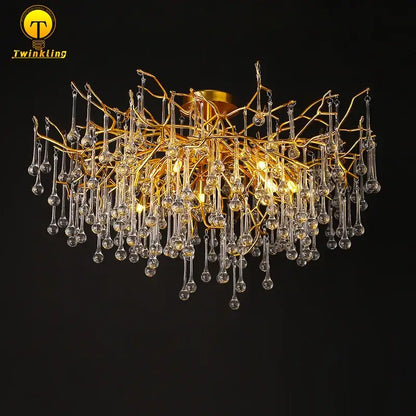 Gold tree branch chandelier featuring dangling clear crystal droplets ideal for elegant dining room lighting