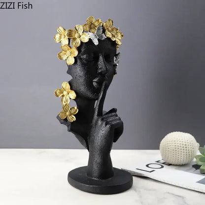 Black resin sculpture garland figure with golden flowers and silver butterflies making a shh gesture decorbites gold silence