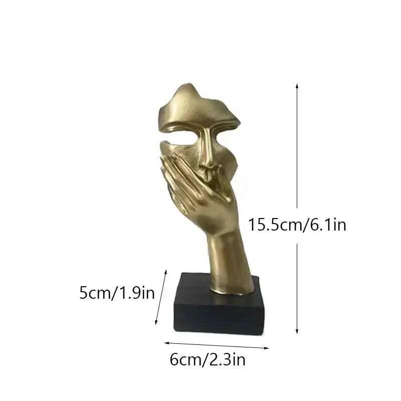 Golden abstract mask statue with hand covering mouth in metallic finish on black base for home office decor
