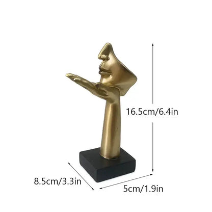 Golden metallic abstract mask statue featuring a stylized hand with face profile on black base for home office decor