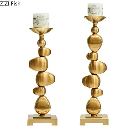 Golden alloy stone pile candle holder with stacked stone-inspired design and sleek metallic finish for living room decorbites golden alloy decor