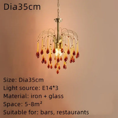 A brass-finished chandelier with cascading amber and clear crystal water drop beads for dining room lighting
