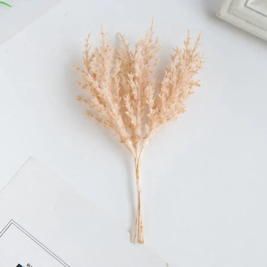 Golden artificial autumn branches set with delicate dried pampas grass in soft peach and beige tones for decorbites artificial autumn