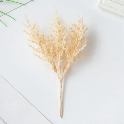 A delicate beige dried grass arrangement with feathery plumes in a golden artificial autumn branches set decorbites decor