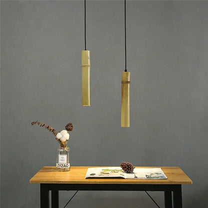 Two minimalist golden bamboo tube pendant lights with adjustable wire perfect for dining room pendant lights