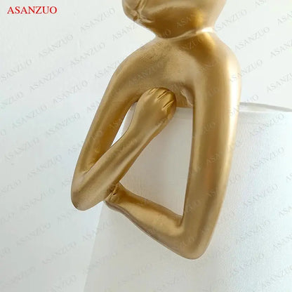 Golden metallic bathing rabbit resin table lamp with smooth abstract contours for bedroom decor by decorbites