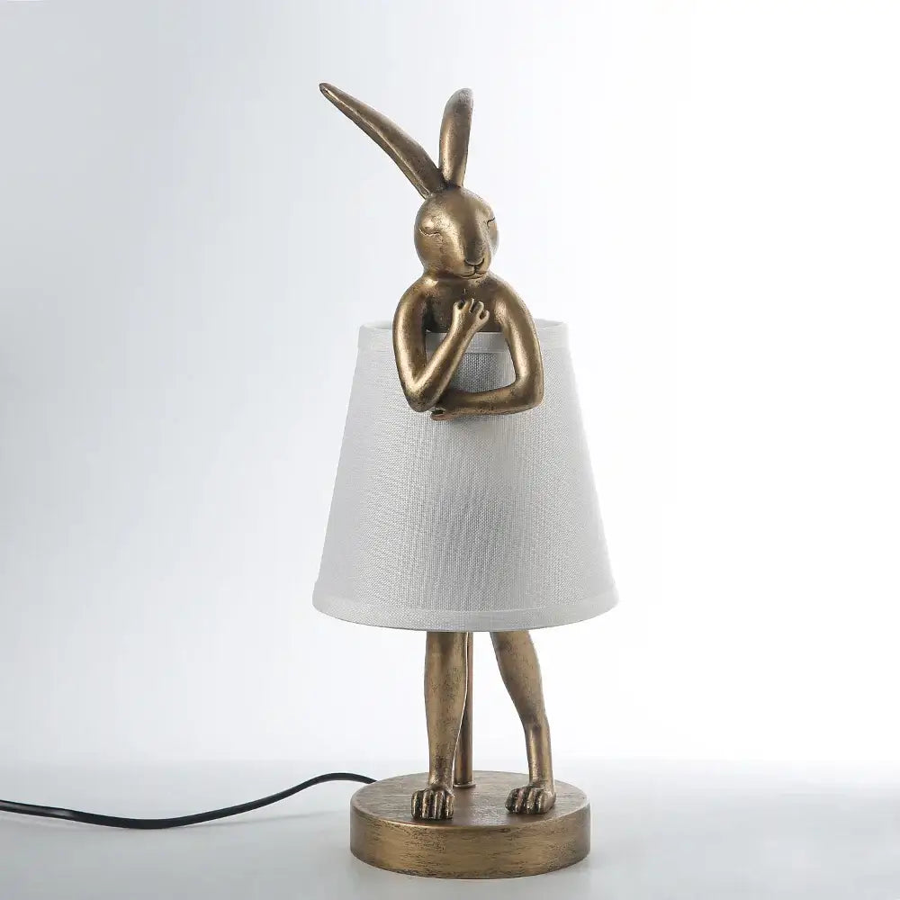 Golden bathing rabbit resin table lamp with white fabric shade for bedroom decor by decorbites bathing rabbit