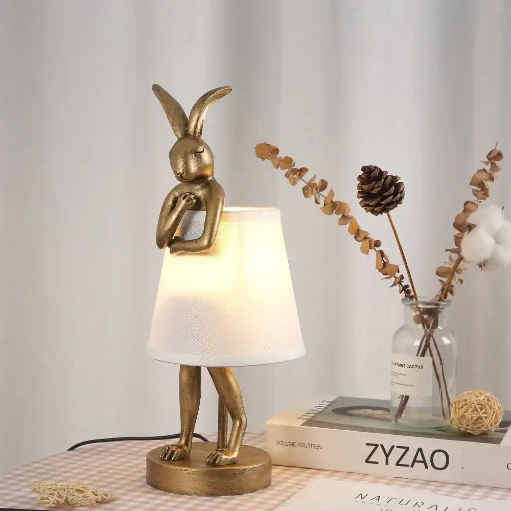 Golden bathing rabbit resin table lamp with white fabric shade for elegant bedroom decor by decorbites bathing rabbit