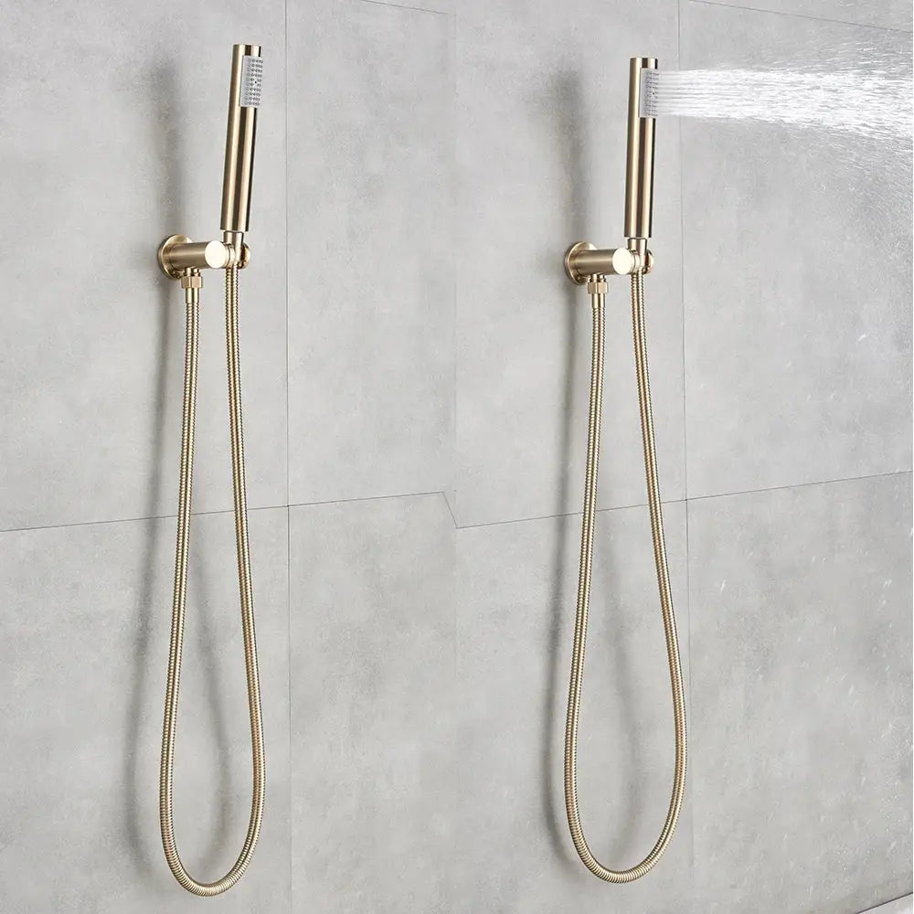 Two gold-toned decorbites golden bathtub faucet shower heads with braided hoses mounted on tiled wall with rotating spout
