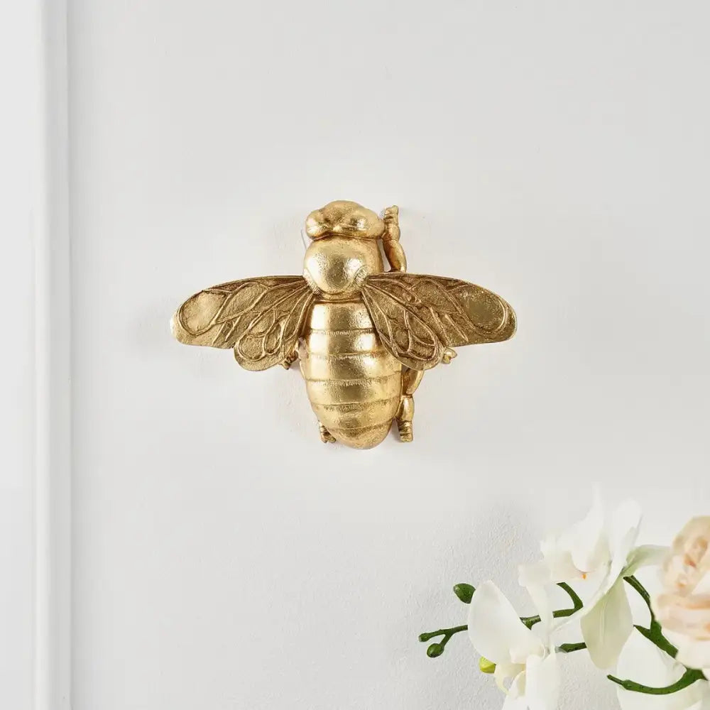 Golden bee resin wall hanger with detailed wings and segmented body for living room decor by decorbites golden bee
