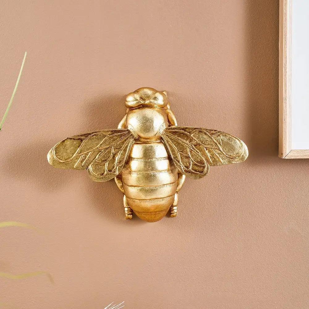 Golden bee resin wall hanger with intricately detailed textured wings and segmented body for living room decorbites golden bee decor